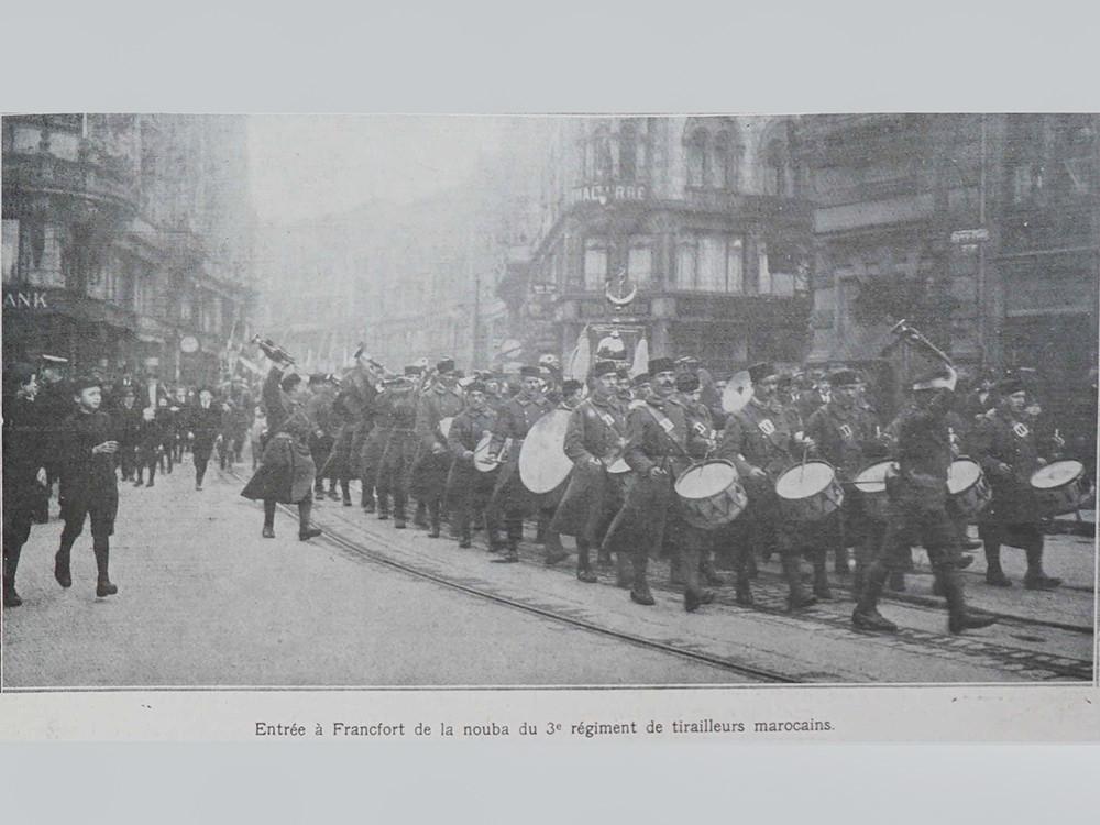 <p style="text-align: center;"><strong>The marching band of the 3rd Regiment of Moroccan 'tirailleurs' in April 1920, Frankfurt am Main. 'L'illustration' newspaper, 1920.</strong><br style="text-align: center;" /><span style="text-align: center;">Source / Cr&eacute;dit :&nbsp;</span><a style="text-align: center;" href="https://commons.wikimedia.org/wiki/File:3e_ri_entrait_%C3%A0_Francfort_Illustration_1920.JPG?uselang=fr" target="_blank" rel="noopener">G. GARITAN - Wikip&eacute;dia CC</a></p>